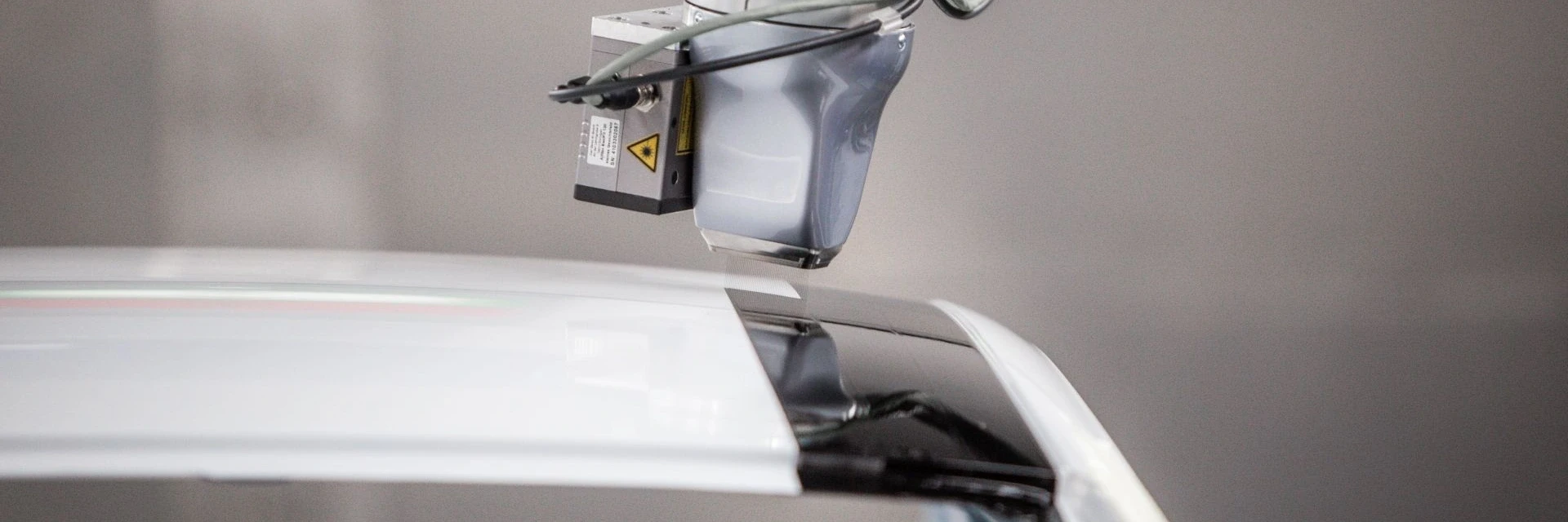 View of EcoPaintjet spraying the surface of a car body